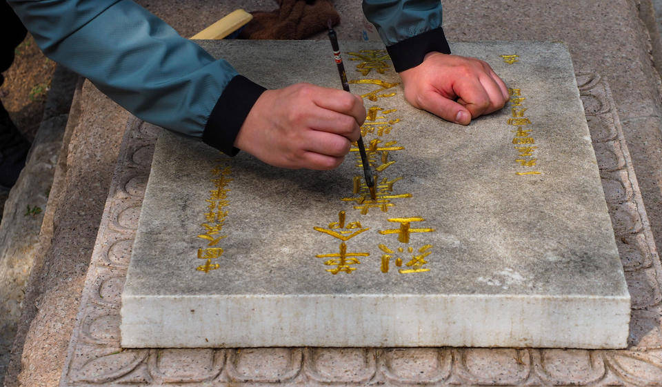 革命烈士永垂不朽济南志愿者为英雄山烈士墓碑描金