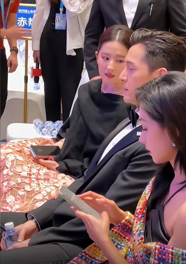 但脸还是很严肃的朝前看,根本不回应刘亦菲的眼神交流,但是在跟万茜